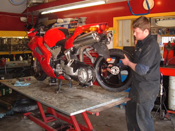 Technician servicing a sportbike